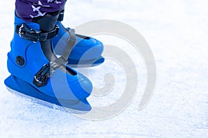 Legs of an ice skater in old vintage skates. Ice skratched background