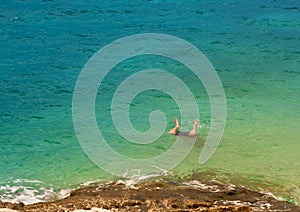 Legs of a man jumping into sea