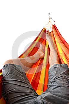 Legs of man lying down in bright hammock isolated on white background