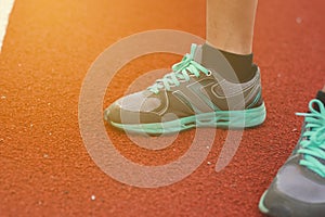 Legs of a man stand on the track on a sunny spring