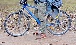 Legs of parent and child with bicycle