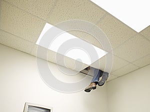 Legs peeping from hole in ceiling