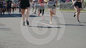 Legs of people competing in marathon