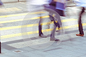 legs of people walking on zebra crossing on rush hour