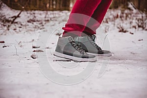 Legs of a person ready to run on the snow path at winter close up