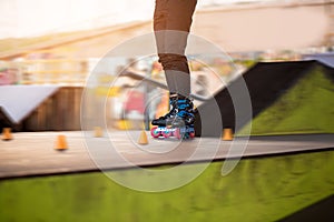 Legs of person on rollerblades.
