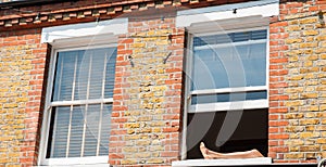 Legs resting on windowsill of open window photo