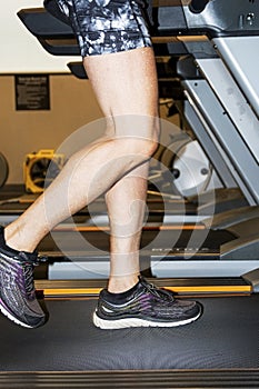 Legs of a runner running on a treadmill