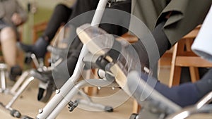 Legs of senior people pedaling sitting on a nursing home