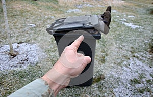 Legs and shoes of a man peeking out of the trash. Homeless man sleeping, looking for garbage inside. outrageous behavior. fall hea