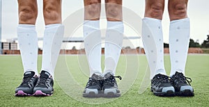 Legs, shoes and woman hockey team outdoor on a field for a game or competition together in summer. Fitness, training or