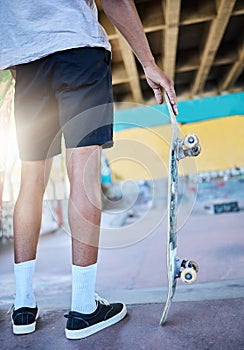 Legs, skateboard and man at skate park, urban and skating for fun and fitness, trendy and active sport. Skater, sneakers