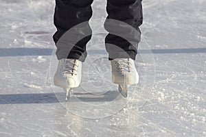 Legs of a skating man on an ice rink. hobbies and leisure. winter sports