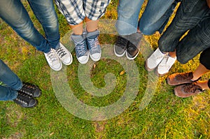 Legs and sneakers of teenage boys and girls