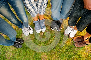 Legs and sneakers of teenage boys and girls