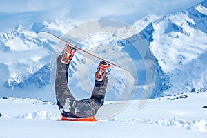 Legs of a snowboarder stuck in snow