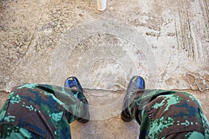 Legs of soldiers wearing leather boots, combats on cement floors, background images