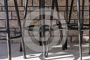 The legs of some bar stools