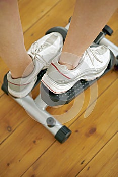 Legs stepping on exercise equipment. Conceptual image shot