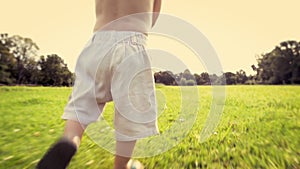 Legs, summer and baby boy running on grass in excitement for adventure, discovery or to explore nature. Kids, growth and