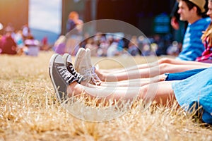 Legs of teenagers, music festival, in front of stage