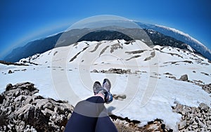 Legs of traveler sitting on a high mountain top in travel,Turkey
