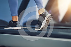 Legs of two girl friends working out on treadmill