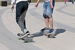 legs of two teenager on a skateboard