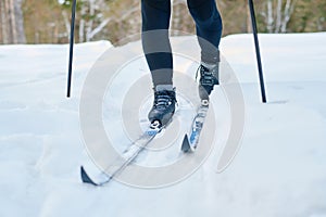 Legs Of Unrecognizable Person Skiing On Winter Day