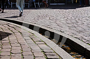 Legs of walking people in pedestrian zone