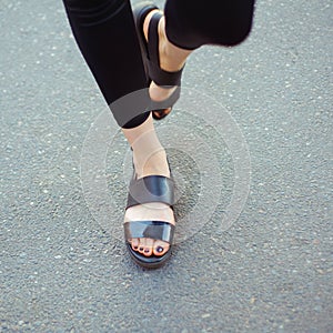 Legs of walking stylish woman