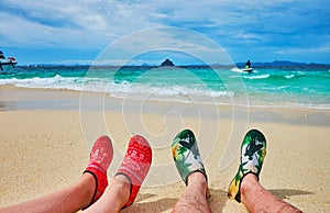 Legs in water shoes, Khai Nok island, Phuket, Thailand