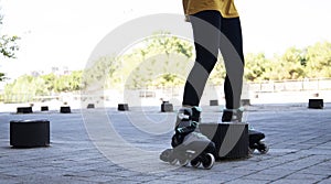 Legs of woman dodging bollards with skates