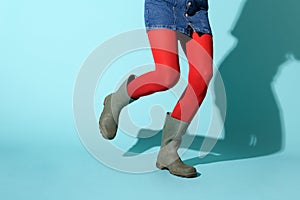 Legs of a woman running in red leggings and rubber boots