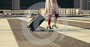 Legs, woman and walking with luggage for business outdoor on ground of rooftop, building or city for trip. Professional