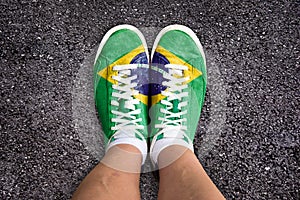 Legs wth sport shoes colored the brazilian flag