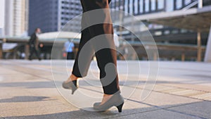 Legs of young businesswoman walking