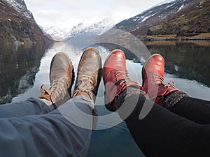 Legs of a young couple near the lake