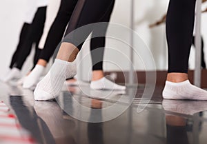 Legs of young dancers ballerinas in class