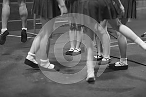 Legs of young female artists participating in the dance ensemble