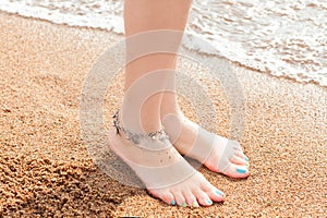 Legs of a young girl and anklet ankle