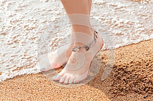 Legs of a young girl and anklet ankle photo