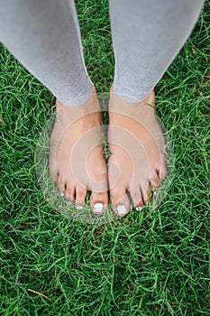 Legs of a young girl on the grass