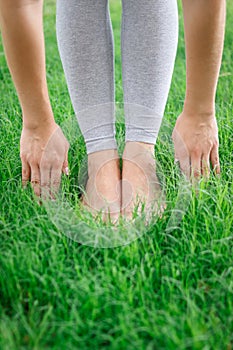 Legs of a young girl on the grass