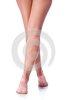 Tanned female legs isolated on white background