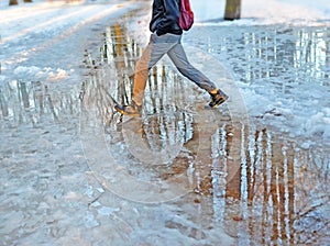 Legs of young man who walks through park in the early spring