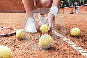 Legs of young woman wearing white skirt on the tennis court