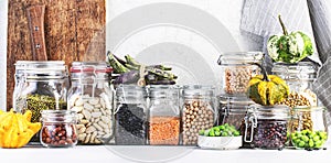 Legumes and beans set in jars. Dried, raw and fresh. Lentils, chickpeas, mung beans, soybeans, edamame, peas. Healthy diet food,