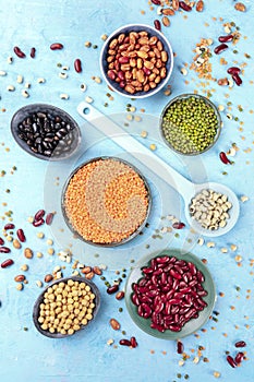 Legumes, overhead shot on a blue background. Vibrant pulses