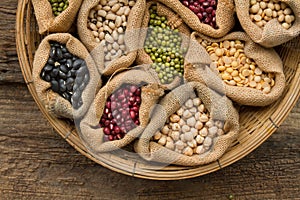 Legumes seed bean in sack bag on wooden background